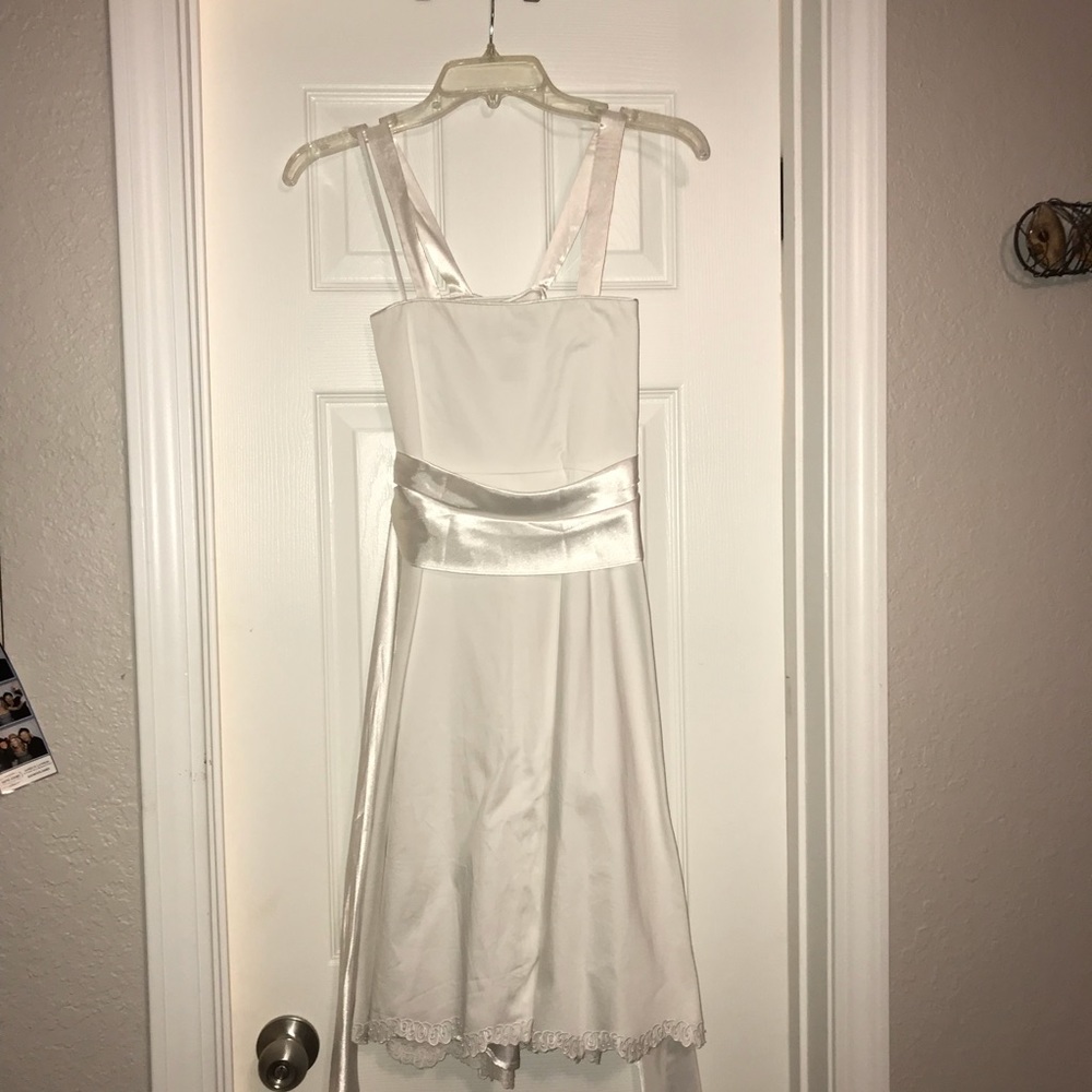White Dress with sash and flower detail.